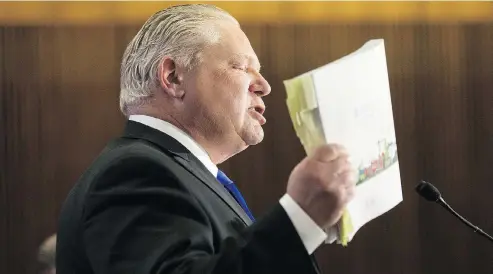  ?? CHRIS YOUNG / THE CANADIAN PRESS ?? Ontario PC Leader Doug Ford with a copy of the Ontario budget during a lock-up last week. He quipped there might be some money to be cut from the CBC budget (federal jurisdicti­on), something Chris Selley took as a joke but others took seriously.