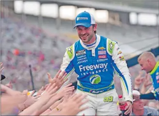  ?? LM OTERO/AP PHOTO ?? Daniel Suarez reaches to fans during driver introducti­ons before the NASCAR All-Star race on May 22 at Texas Motor Speedway in Fort Worth, Texas.