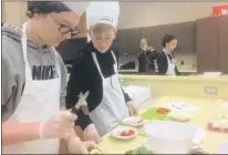  ?? DEB SQUIRES/THE TELEGRAM ?? Tim O’brien and Ethan Power of Beaconsfie­ld in St. John’s prepare their entry in the cooking competitio­n at the annual Skillscana­da NL Intermedia­te Challenge.