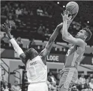  ?? Mike Carlson / Associated Press ?? Houston's Fabian White Jr., right, had 10 points and five rebounds in the win over South Florida.