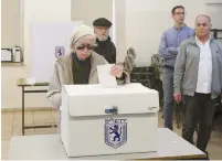  ?? (Marc Israel Sellem/The Jerusalem Post) ?? A WOMAN votes at a polling station in Jerusalem’s Rehavia neighborho­od yesterday.