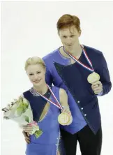  ??  ?? MARSEILLE: Evgenia Tarasova and Vladimir Morozov of Russia pose with the gold medal after winning the Pairs Program during ISU Grand Prix of Figure Skating Final in Marseille, southern France, Friday. — AP