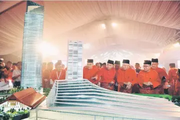  ??  ?? Najib (front row, second right) and Zahid taking a closer look at the PWTC KL replica model. — Bernama photo