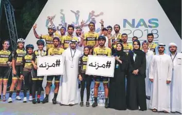  ?? Courtesy: Organiser ?? Al Wathba cycling team members join NAS organisers in remembranc­e of late Mizna Abdullah Ali, who was killed by a speeding car last Wednesday while training for the cycling competitio­n.