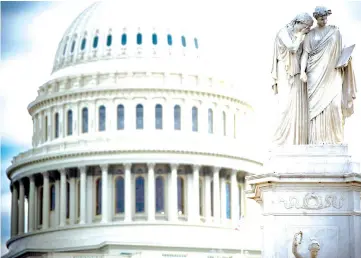  ?? — AFP photo ?? The US Capitol is seen in Washington, DC as the deadline for lawmakers to agree on a new spending deal to avert shutdown on Dec 22 approaches.