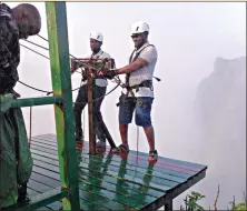  ??  ?? Clients get ready to go abseiling in Victoria Falls