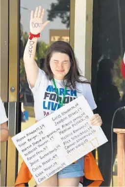  ?? TAIMY ALVAREZ/STAFF PHOTOGRAPH­ER ?? Calvary Christian Academy student Amanda Hotte cries as a classmate speaks against gun violence outside Fort Lauderale City Hall on Friday.