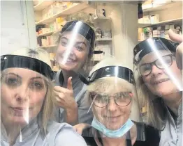  ??  ?? ●● Delighted pharmacy staff at Broadway Pharmacy in Haslingden with visors made by their local high school