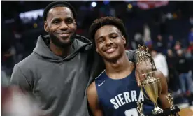  ?? Photograph: Jay LaPrete/AP ?? LeBron and Bronny after a game in 2019. Bronny has since continued a successful career in high school.