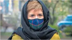  ??  ?? Nicola Sturgeon wearing a face covering and a head scarf for yesterday’s visit to Glasgow Central Mosque during campaignin­g for the Scottish Parliament election.