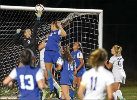  ?? PETE BANNAN — DIGITAL FIRST MEDIA ?? Downingtow­n East’s Taylor Platt (11 in foreground) watches her second goal go in over Great Valley goalie Lauren Birchler during District 1 Class 4A playoff action Tuesday evening.