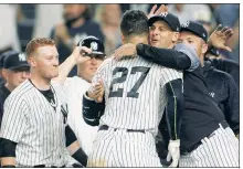  ?? Robert Sabo ?? HUG IT OUT! Aaron Boone hugs Giancarlo Stanton after the slugger’s game-winning homer in the ninth.