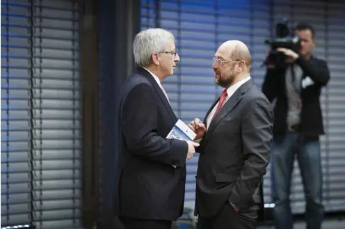  ?? Foto: imago/Thomas Trutschel ?? März 2014, Berlin: Zwei Gesichter für Europa – Jean-Claude Juncker (l.) und Martin Scholz