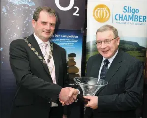  ??  ?? Sligo Chamber of Commerce, Mr Fergal Burke, making a presentati­on to the late The Sligo Champion Editor, Seamus Finn, to mark his retirement and long service in 2010.