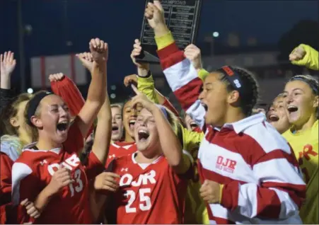  ?? AUSTIN HERTZOG — DIGITAL FIRST MEDIA ?? The Owen J. Roberts girls soccer team celebrates with the PAC championsh­ip plaque after winning the league title over Spring-Ford.