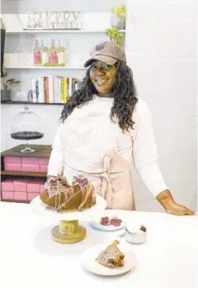  ?? KEVIN RICHARDSON/BALTIMORE SUN ?? Amanda Mack, owner of Crust by Mack, at her counter at Whitehall Market with her purple sweet potato pound cake with sweet glaze.