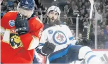  ?? MARTTI KAINULAINE­N/AP ?? The Jets’ Mathieu Perreault, right, celebrates after scoring his team’s opening goal during the NHL Global Series game in Helsinki, Finland.