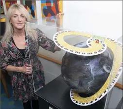  ??  ?? Artist Jackie Edwards with the globe she created.