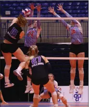  ?? (Arkansas Democrat-Gazette/Colin Murphey) ?? Fayettevil­le’s Maddie LaFata (left) hits the ball over the net Saturday as two Fort Smith Southside players try to block during the Lady Bulldogs’ 3-0 victory over the Lady Mavericks in the Class 6A state volleyball championsh­ip at Bank OZK Arena in Hot Springs.