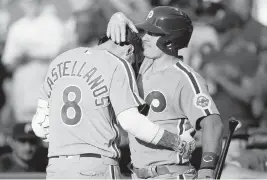  ?? MATT SLOCUM AP ?? Philadelph­ia’s Nick Castellano­s is congratula­ted by J.T. Realmuto after hitting a three-run home run in the second inning of Thursday night’s game against the Braves.