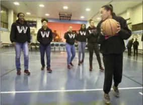  ?? CHARLES FOX — THE PHILADELPH­IA INQUIRER VIA AP ?? At the conclusion of Dawn Staley Day, Staley, right, has each of her South Carolina players make a jump shot as “rite of passage” in the Hank Gathers Recreation Center where she grew up playing, Wednesday in Philadelph­ia.
