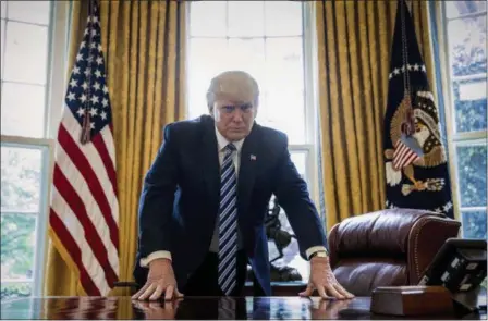  ?? ANDREW HARNIK — THE ASSOCIATED PRESS ?? President Donald Trump poses for a portrait in the Oval Office in Washington, Friday. With his tweets and his bravado, Trump is putting his mark on the presidency in his first 100 days in office.