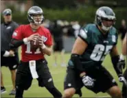  ?? MATT ROURKE — THE ASSOCIATED PRESS ?? Philadelph­ia Eagles quarterbac­k Carson Wentz (11) and tackle Lane Johnson (65) run through a drill during the team’s training camp last summer. Wentz will get his first start of the season Sunday against the Colts.