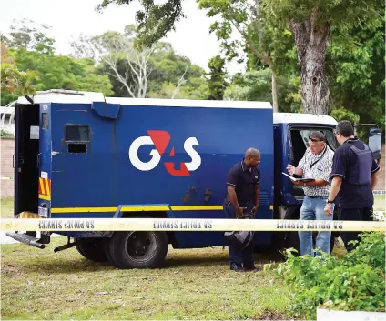  ?? Picture: Gallo Images ?? DANGER JOB. Security officers and officials with an armoured truck after a cash-in-transit heist in March at Walmer in Port Elizabeth.