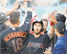  ?? RICK KINTZEL/THE MORNING CALL ?? The IronPigs’ Austin Listi receives high-fives from teammates after he hit a solo home run early in Friday’s Triple-A game against Scranton/Wilkes-Barre.