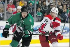  ?? — THE ASSOCIATED PRESS ?? Stars’ Jamie Benn is covered by Carolina Hurricanes’ Riley Nash in Dallas on Thursday.