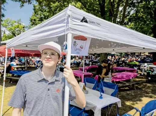  ?? Photos by Skip Dickstein/special to the Times Union ?? Griffen Miller sets up his canopy on Saturday at the Saratoga Race Course in Saratoga Springs. Miller has been operating since the beginning of track season and has already had repeat customers.