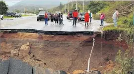  ??  ?? HIGHWAY 10 opened a gateway to the region, but damage from landslides trapped residents in the hills. “We’re waiting, waiting for help,” the mayor says.