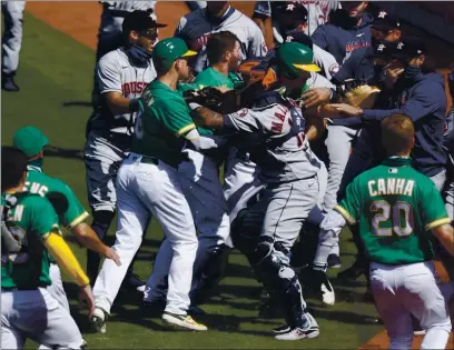  ?? NHAT V. MEYER — STAFF PHOTOGRAPH­ER ?? The Athletics and Astros battle it out after the A’s Ramon Laureano charged Houston hitting coach Alex Cintron in August.