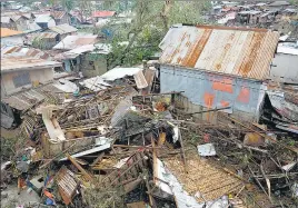  ?? ?? Debris is scattered over damaged homes from Typhoon Rai in Talisay, Cebu province, central Philippine­s on Friday.