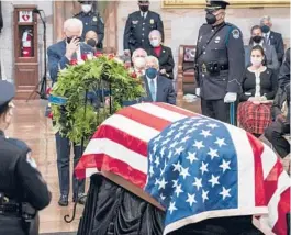  ?? JABIN BOTSFORD/THE WASHINGTON POST VIA AP, POOL ?? President Biden pays respects to Bob Dole as the former senator lies in state Thursday in the Capitol Rotunda in Washington.