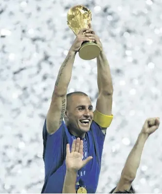  ?? THE ASSOCIATED PRESS FILES ?? Italy’s team captain Fabio Cannavaro holds aloft the World Cup trophy after the final between Italy and France in the 2006 World Cup in Berlin, Germany. The best players in the world go elsewhere. The best coaches in Italy emigrate. The stadiums around...