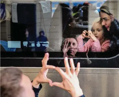  ?? Emilio Morenatti/Associated Press file photo ?? Nicolai, 41, says goodbye to his daughter Elina, 4, and his wife, Lolita, on a train April 15 as they leave Lviv, Ukraine, bound for Poland amid the Russian invasion.