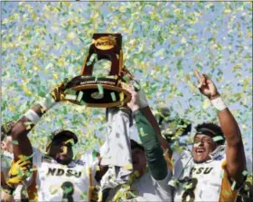  ?? VERNON BRYANT — THE DALLAS MORNING NEWS VIA AP ?? in the semifinals. Ethan Ratke had two field goals but missed one in the first half. North Dakota State safety Tre Dempsey (3), head coach Chris Klieman and running back Bruce Anderson (8) celebrate after defeating James Madison 17-13 in the FCS...