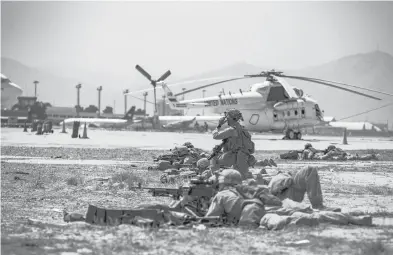  ?? 1ST LT. MARK ANDRIES/U.S. MARINE CORPS ?? Marines assigned to the Special Purpose Marine Air Ground Task Force-crisis Response-central Command provide security at Hamid Karzai Internatio­nal Airport in Kabul, Afghanista­n.