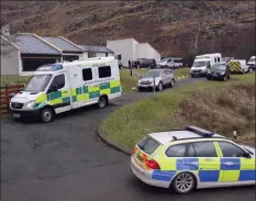  ??  ?? Convoy: Police and ambulance crews leave the hostel