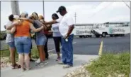  ??  ?? People pray outside Ride the Ducks, an amphibious tour operator involved in a boating accident on Table Rock Lake, Friday, in Branson, Mo.