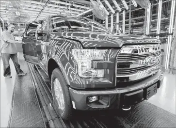  ?? Charlie Riedel Associated Press ?? WOULD-BE BUYERS continue to gravitate to crossover SUVs while trucks and full-size SUVs have shown increased miles per gallon across product lines. Above, a Ford F-150 truck at a factory in Missouri in 2015.