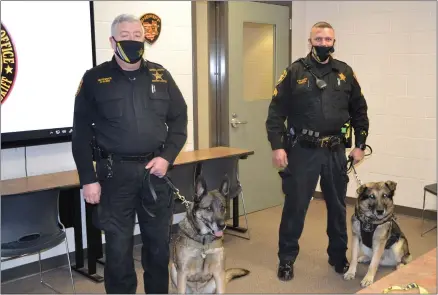  ?? SHEENA HOLLAND DOLAN — THE NEWS-HERALD ?? Geauga County Deputy Jim Dhayer and K-9Miner, left, and Sgt. Jake Smith and K-9Spirit stopped in for a visit while Lake Church of Christ members presented their unit with a donation.