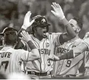  ?? Lindsey Wasson / Getty Images ?? Cameron Maybin, center, has been a surprising offensive spark during his first week with the Astros.