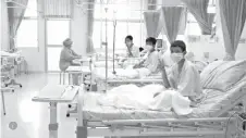  ?? Thailand Government Spokesman Bureau via AP ?? ■ In this image made from video released by the Thailand Government Spokesman Bureau, three of the 12 soccer players rescued from a cave in Thailand are shown Wednesday in their hospital bed.