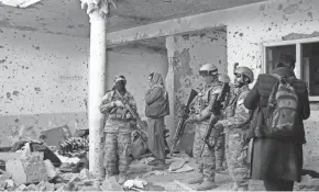  ?? SHIR SHAH HAMDARD/AP ?? Taliban fighters inspect a house after an 8-hour gunbattle erupted between Taliban and Islamic State group fighters Tuesday.