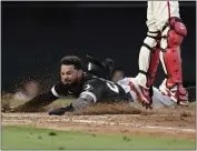  ?? JAE C. HONG – THE ASSOCIATED PRESS ?? Leury Garcia scores one of the White Sox's five runs in the fifth inning on a double by Seby Zavala as Angels catcher Kurt Suzuki jumps to catch the throw home.