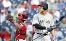  ?? NICK WASS — THE ASSOCIATED PRESS ?? Aaron Judge walks back to dugout after striking out in ninth inning of Yankees’ 5-3 loss to Nationals on Monday in continuati­on of a suspended game from May 15.