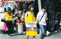  ?? (Ronen Zvulun/Reuters) ?? A TEENAGER wears a Purim costume as a reference to the coronaviru­s in Jerusalem on Sunday.