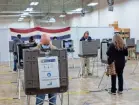  ?? ADAM CAIRNS/COLUMBUS DISPATCH ?? Voters in Delaware County cast their ballots during early voting on Tuesday.